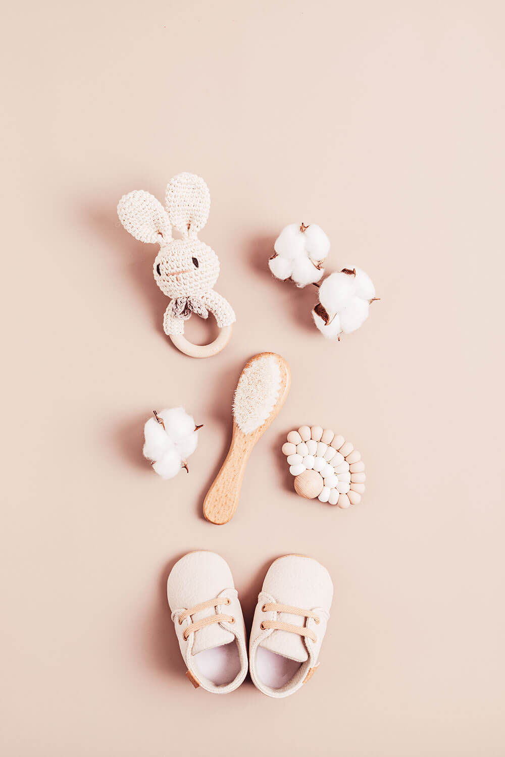Baby accessories on a beige background.